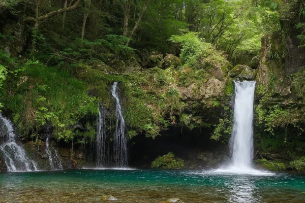 Mountain waterfall cascading over moss-covered rocks in pristine forest setting near Mount Fuji